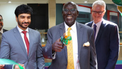 DR. Steve Mainda, DIB Bank Board Member with Dr. Khalifa AlRayssi, Charge D'affaires (Ambassador)– Embassy of the UAE cuts the ribbon to officially launch DIB Bank Sarit Branch, looking on Dr. Micahel Murphy, Director, DIB Bank.. PHOTO/COURTESY